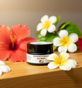 Argan & Coconut Lip Balm close-up with hibiscus and frangipani